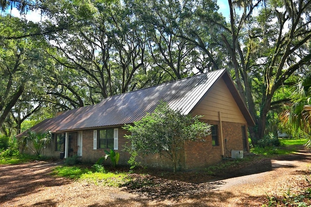 18001 SE Hawthorne Rd, Hawthorne, FL 32640 - view of side of property with metal roof and brick siding