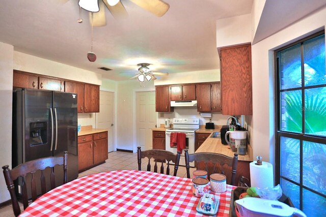 18001 SE Hawthorne Rd, Hawthorne, FL 32640 - kitchen with electric stove, a ceiling fan, under cabinet range hood, and black fridge