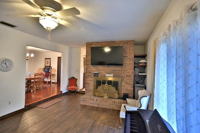 18001 SE Hawthorne Rd, Hawthorne, FL 32640 - living room with a fireplace, ceiling fan with notable chandelier, wood finished floors, and visible vents