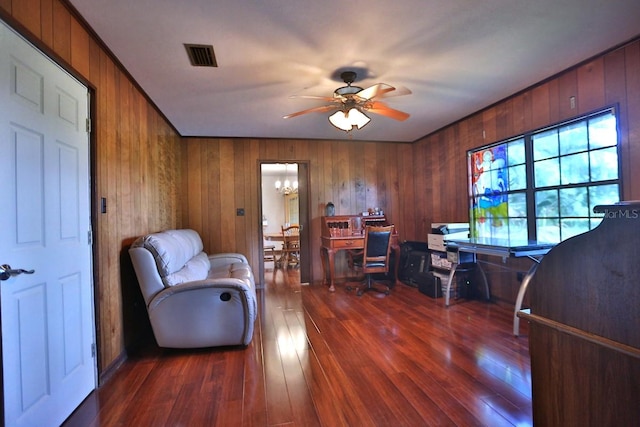 office area featuring wood walls, ceiling fan, and dark hardwood / wood-style flooring