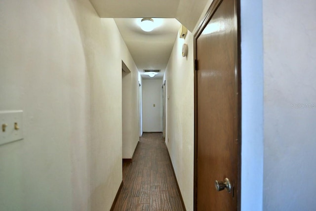 corridor with dark hardwood / wood-style floors