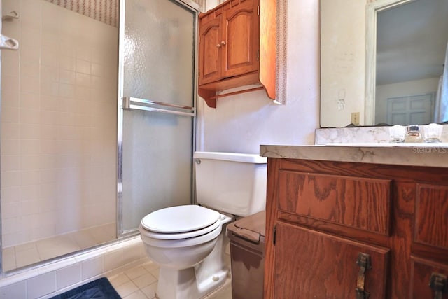 bathroom with toilet, an enclosed shower, vanity, and tile patterned flooring