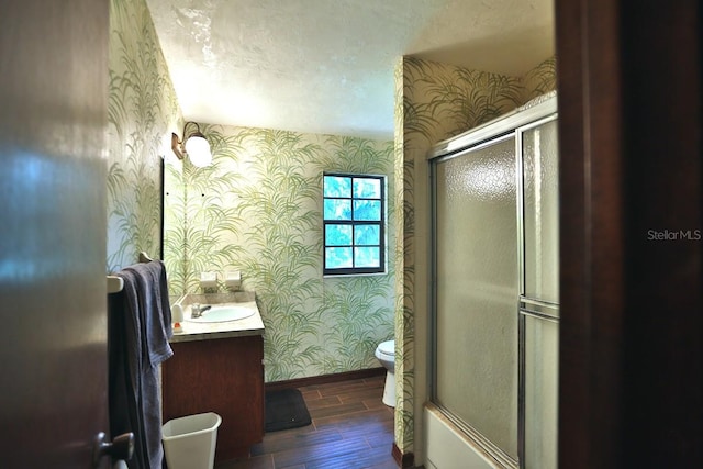 18001 SE Hawthorne Rd, Hawthorne, FL 32640 - bathroom featuring an enclosed shower, wood finished floors, baseboards, toilet, and wallpapered walls