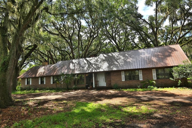 18001 SE Hawthorne Rd, Hawthorne, FL 32640 - ranch-style house with brick siding, a chimney, and metal roof