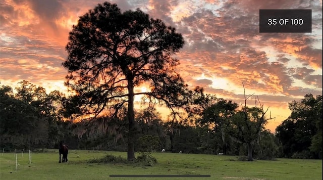 nature at dusk featuring a rural view