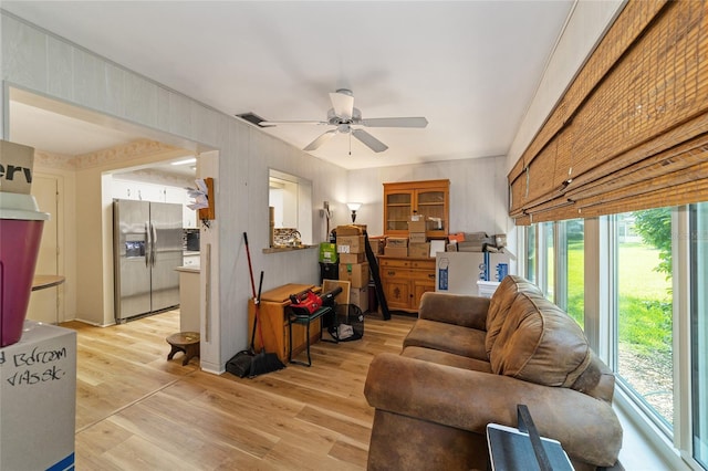 living room featuring ceiling fan and light wood-type flooring