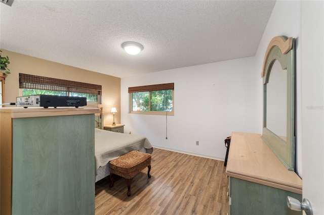 bedroom featuring a textured ceiling and hardwood / wood-style flooring