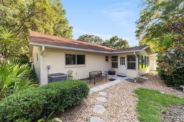 back of house with a sunroom and central AC