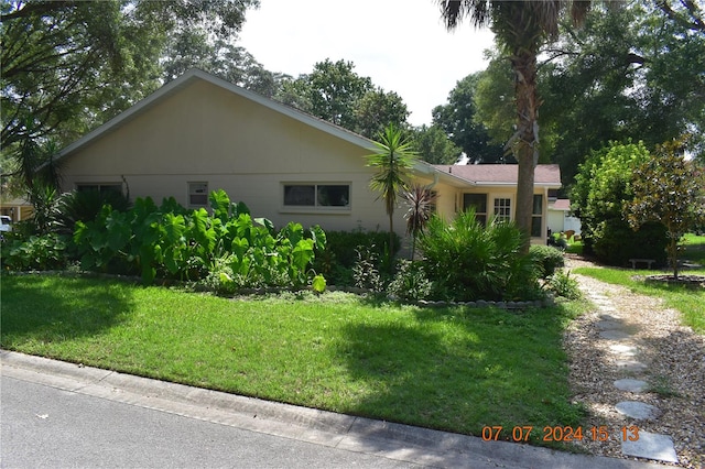 view of side of home featuring a lawn