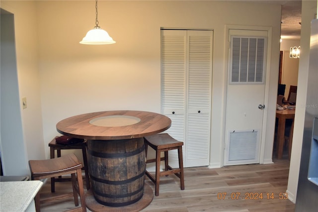 dining space with light hardwood / wood-style floors