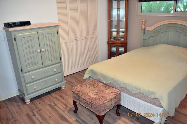 bedroom with a closet and dark hardwood / wood-style flooring