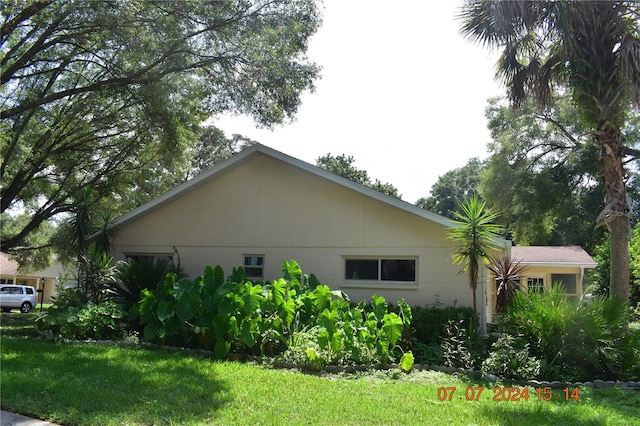 view of property exterior with a lawn