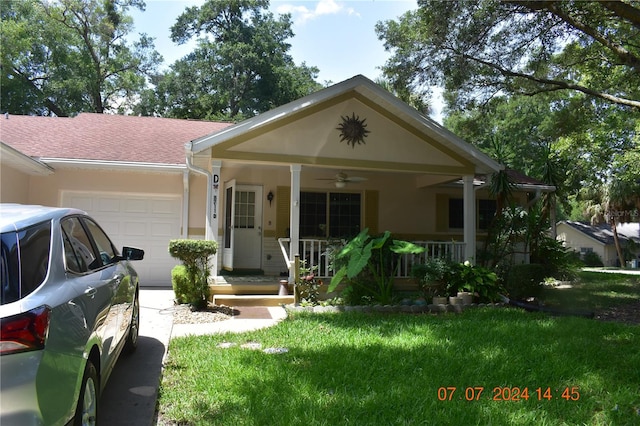 view of front facade featuring a garage, covered porch, and a front yard