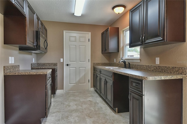 kitchen with dark brown cabinets and sink