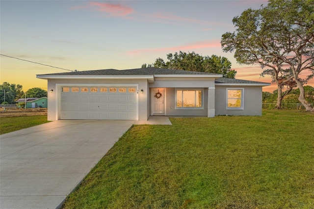 view of front of house with a lawn and a garage