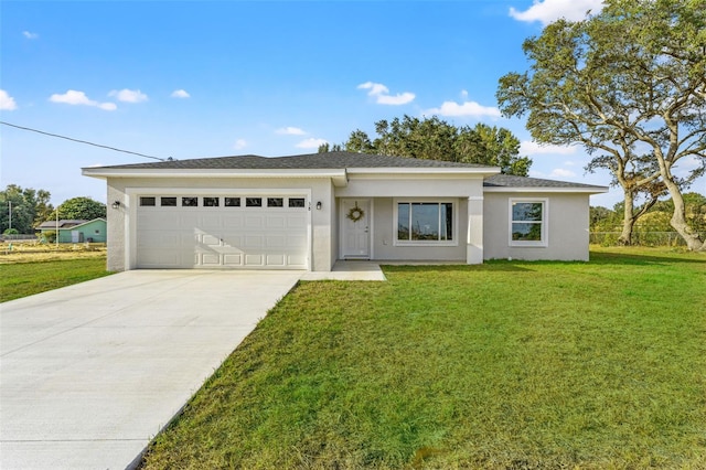 view of front of property with a front yard and a garage