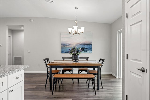 dining space with dark hardwood / wood-style flooring and a notable chandelier