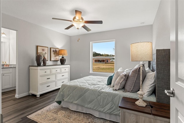 bedroom featuring ceiling fan, dark hardwood / wood-style flooring, and ensuite bathroom