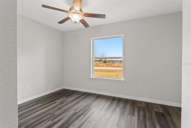 empty room with ceiling fan and dark hardwood / wood-style floors