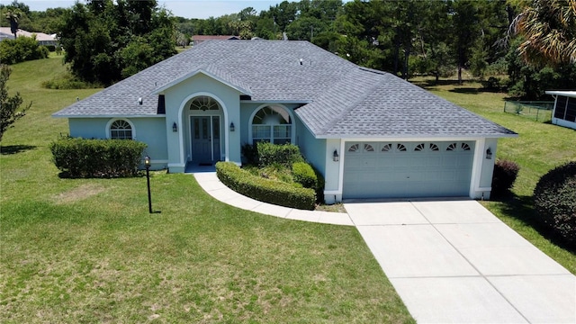 ranch-style home with a garage and a front lawn