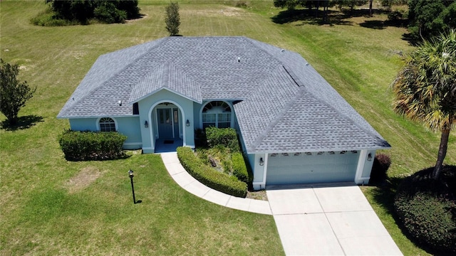 exterior space featuring a garage and a front yard