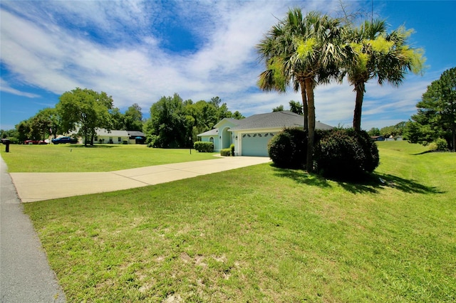 view of front of house with a garage and a front lawn