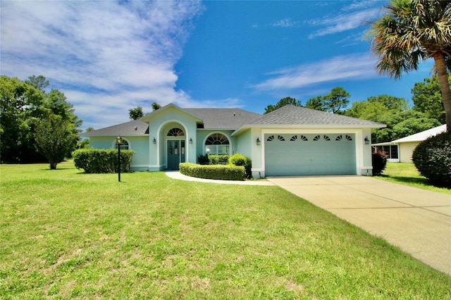 single story home featuring a garage and a front yard