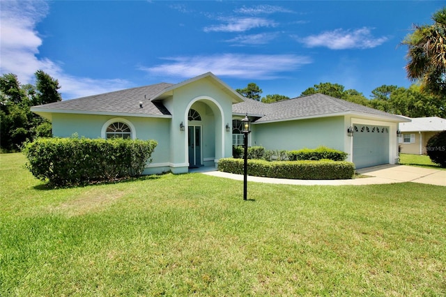 ranch-style home featuring a garage and a front lawn