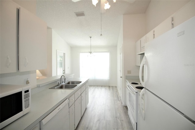 kitchen featuring light hardwood / wood-style flooring, white cabinetry, sink, white appliances, and a textured ceiling