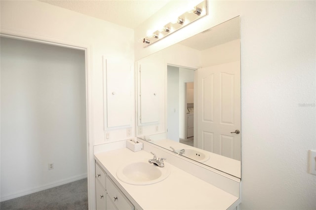 bathroom featuring washer / dryer and vanity