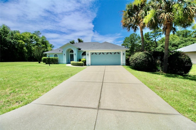 view of front of home with a front yard and a garage