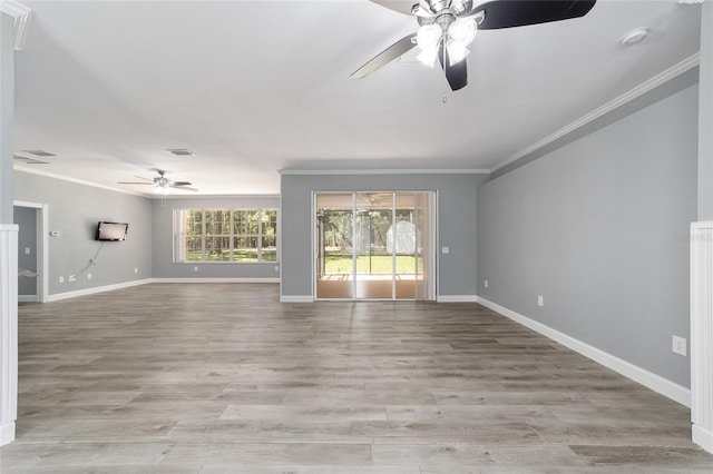 unfurnished living room with light wood finished floors, baseboards, visible vents, ceiling fan, and ornamental molding