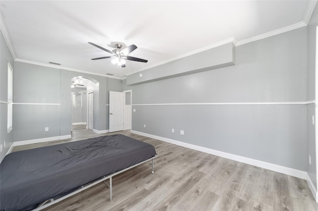 unfurnished bedroom with ceiling fan, light wood-type flooring, and ornamental molding