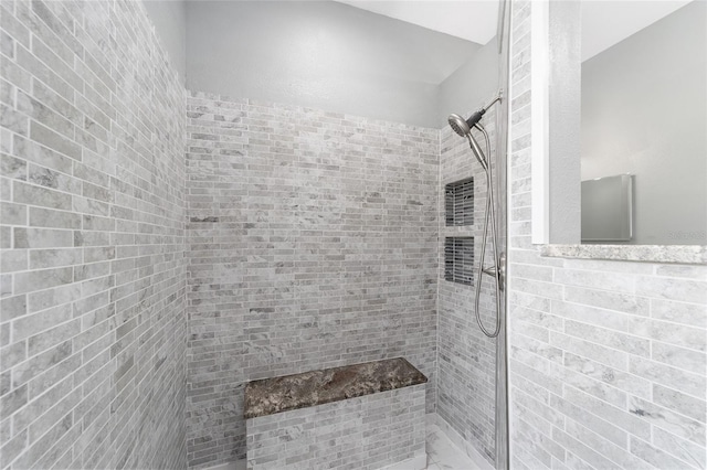 bathroom featuring tiled shower