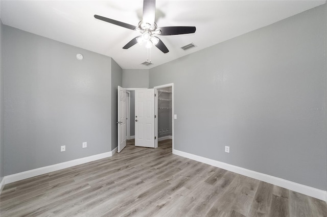 10020 SW 202nd Cir, Dunnellon, FL 34431 - unfurnished bedroom featuring light wood-style flooring, ceiling fan, a closet, and a spacious closet