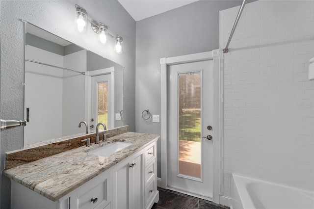 bathroom with shower / bathing tub combination and vanity