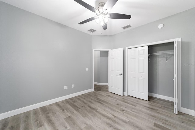 unfurnished bedroom with ceiling fan, light hardwood / wood-style floors, and a closet