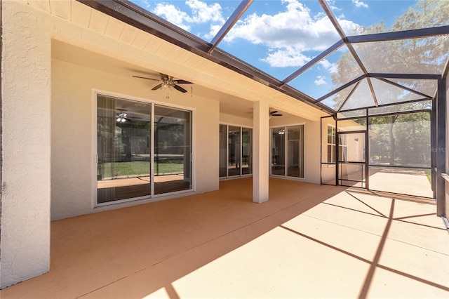 view of patio featuring glass enclosure and ceiling fan