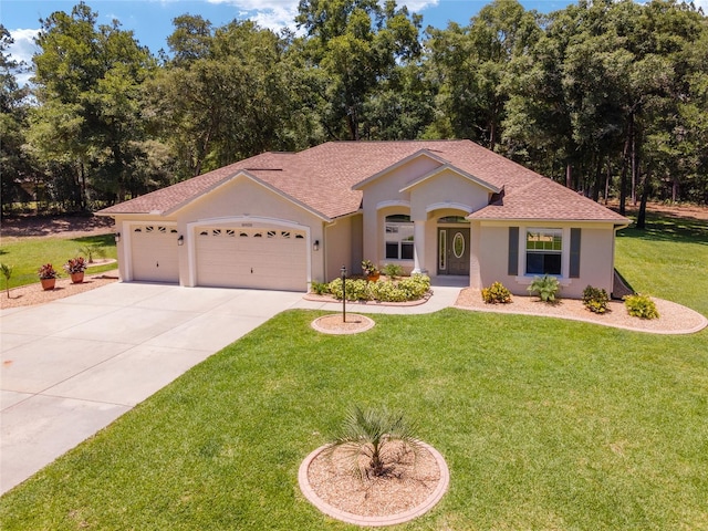 view of front of house featuring stucco siding, a shingled roof, concrete driveway, a front yard, and a garage