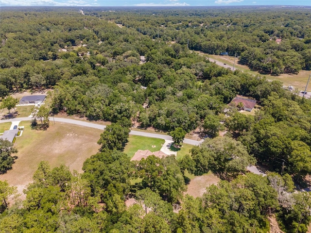 drone / aerial view featuring a forest view