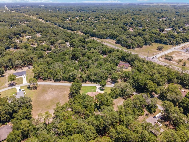 birds eye view of property featuring a forest view