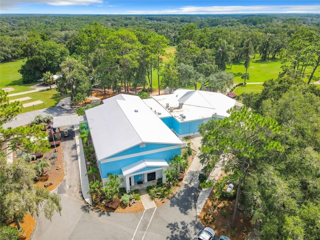 drone / aerial view with a wooded view