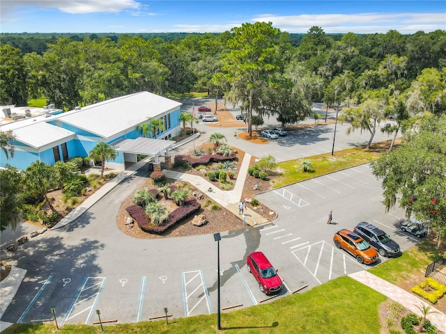 birds eye view of property with a forest view