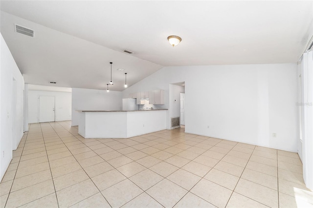 unfurnished living room featuring light tile patterned floors and vaulted ceiling