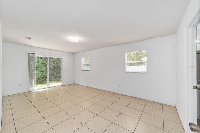 tiled spare room with a wealth of natural light