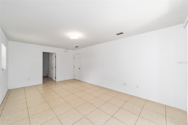 unfurnished room featuring light tile patterned floors