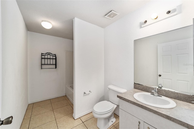 bathroom featuring tile patterned floors, vanity, and toilet