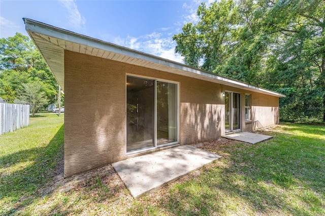 rear view of property with a yard