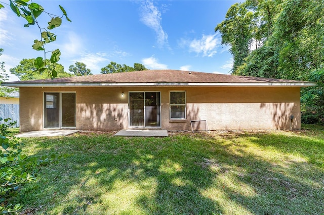 rear view of house with a lawn