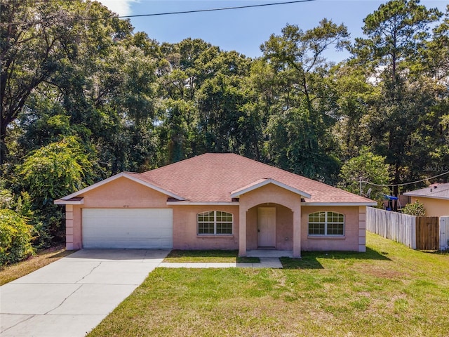 single story home featuring a front yard and a garage